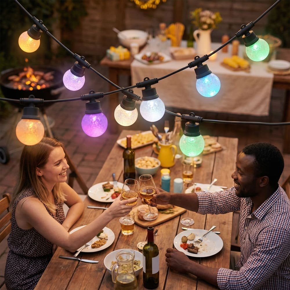 Multicolor LED patio string lights illuminating an outdoor dinner party for festive backyard ambiance