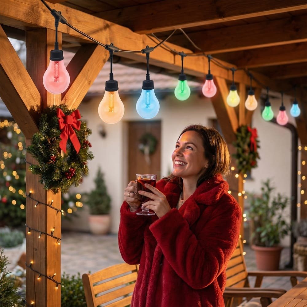 Multi-colored RGB commercial outdoor string lights illuminating wooden patio for festive holiday decoration